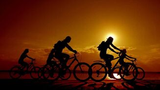 Family biking during sunset